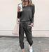 Woman in casual dark gray jogger set with long sleeves, drawstring waist, and relaxed fit