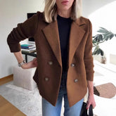 Woman wearing a brown wool double-breasted blazer with ribbed knit sleeves and casual fit