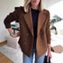 Woman wearing a brown wool double-breasted blazer with ribbed knit sleeves and casual fit
