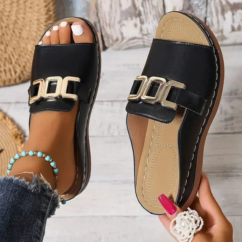 Black slip-on sandals with gold metal buckles, flat sole, casual streetwear style