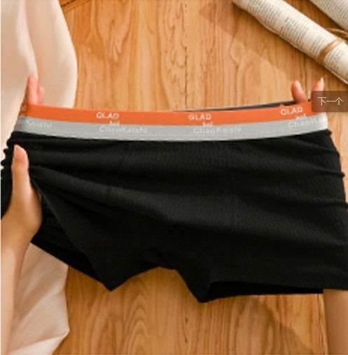 Black boxer briefs with orange and grey elastic waistband, soft textured fabric, comfortable fit