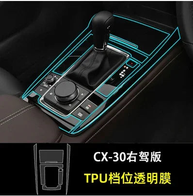 Right-hand drive car gear console with black TPU transparent protective film, highlighted trim.