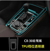 Right-hand drive car gear console with black TPU transparent protective film, highlighted trim.