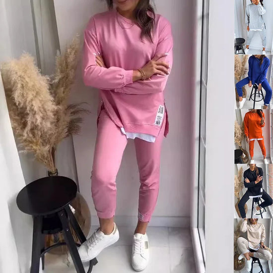 Woman wearing pink oversized sweatshirt and matching joggers, casual fit, cotton material.