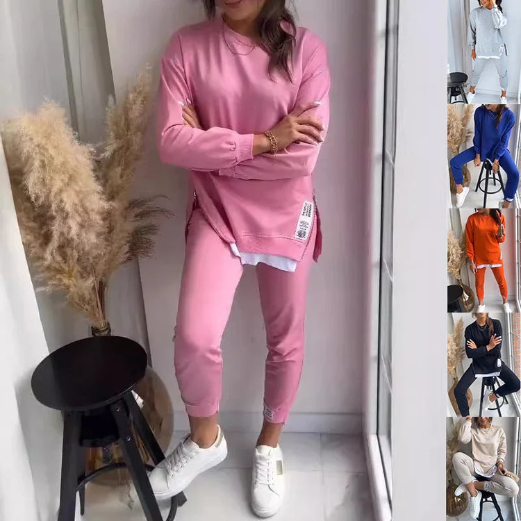 Woman wearing pink oversized sweatshirt and matching joggers, casual fit, cotton material.