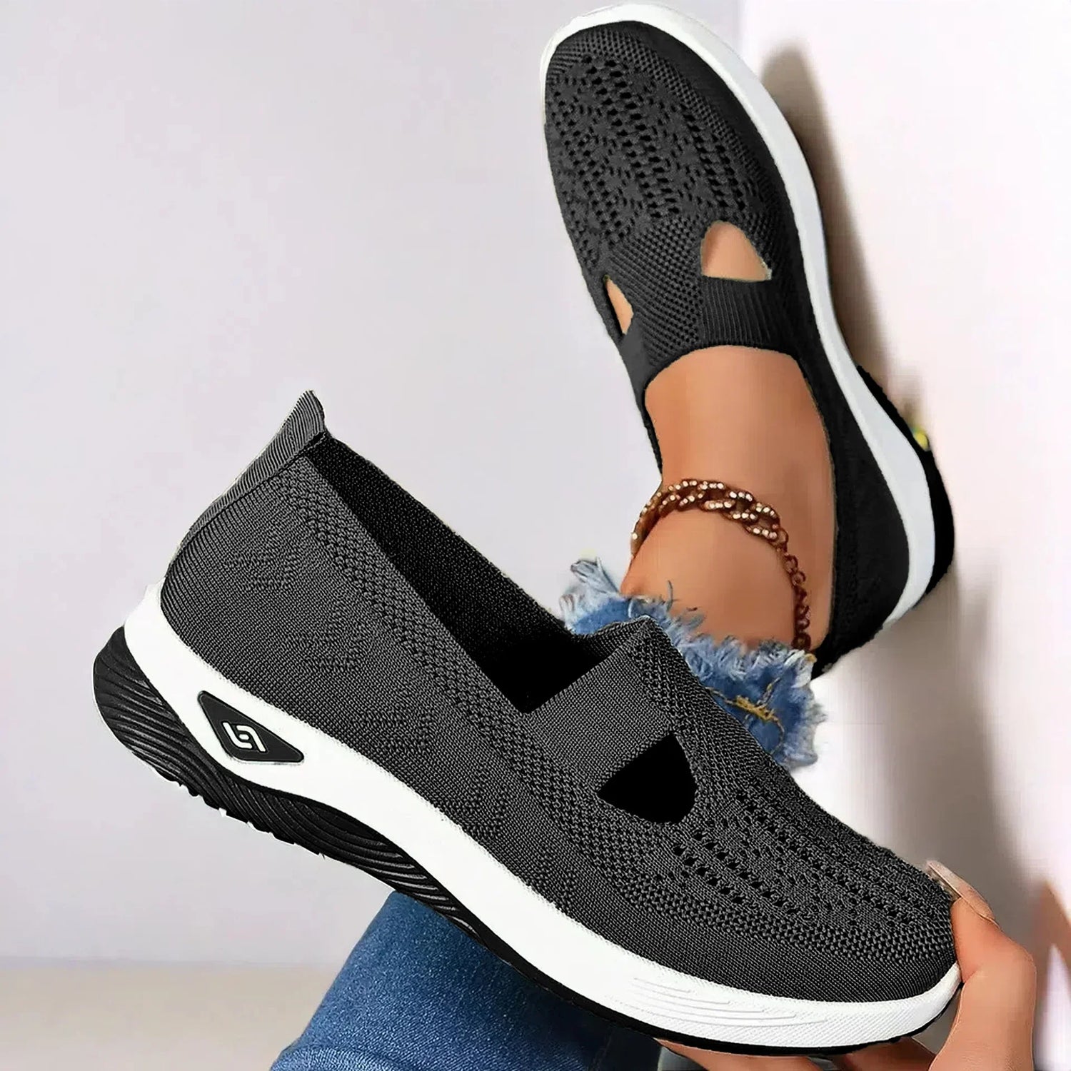 Black knit slip-on shoes with cutout detail, white sole, casual fit, lightweight design