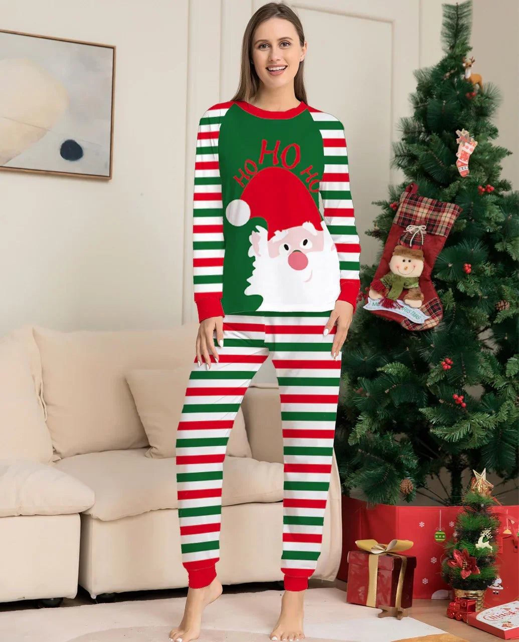 Woman wearing festive striped Christmas pajamas with Santa print, relaxed fit, soft fabric