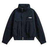Black streetwear bomber jacket, relaxed fit, button-up collar, cotton material, front pockets