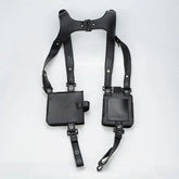Black faux leather utility harness with adjustable straps and two square pockets, streetwear style