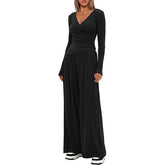 Woman in black long-sleeve, wide-leg jumpsuit, V-neck, relaxed fit, soft fabric