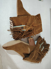 Brown suede ankle boots with fringe, chunky heel, pointed toe, and studded embellishments.