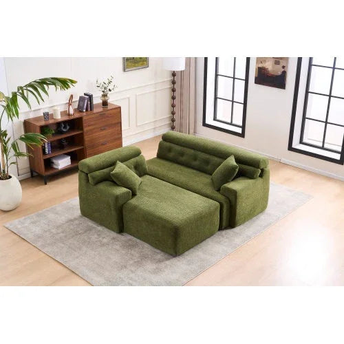 Modern green fabric modular sofa with ottoman and pillows in a bright living room