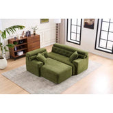 Modern green fabric modular sofa with ottoman and pillows in a bright living room