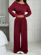 Woman wearing burgundy crop sweatshirt and loose wide-leg lounge pants in soft fabric