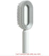 Modern white and gray hairbrush with oval design and ergonomic handle
