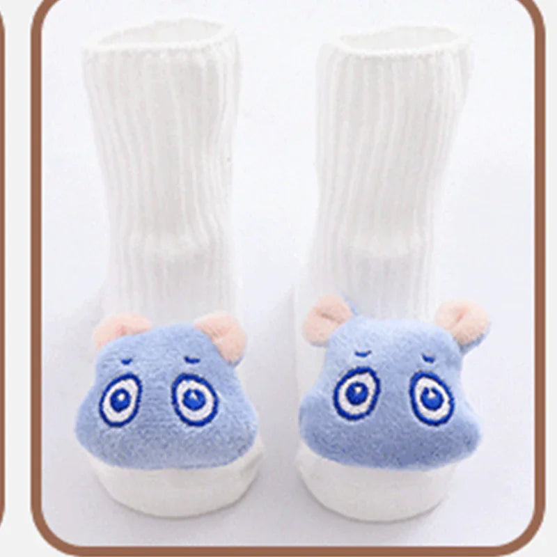White ribbed baby socks with soft blue animal face plush details on the toes