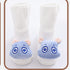 White ribbed baby socks with soft blue animal face plush details on the toes