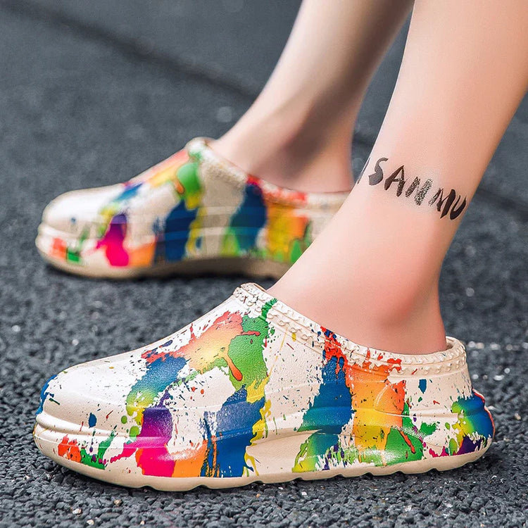 Beige slip-on clogs with colorful paint splatter design, casual streetwear style