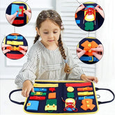 Child in striped long-sleeve dress with loose fit, engaging with colorful felt activity board.