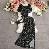 Black floral print short sleeve jumpsuit with wide-leg pants, lightweight fabric, relaxed fit