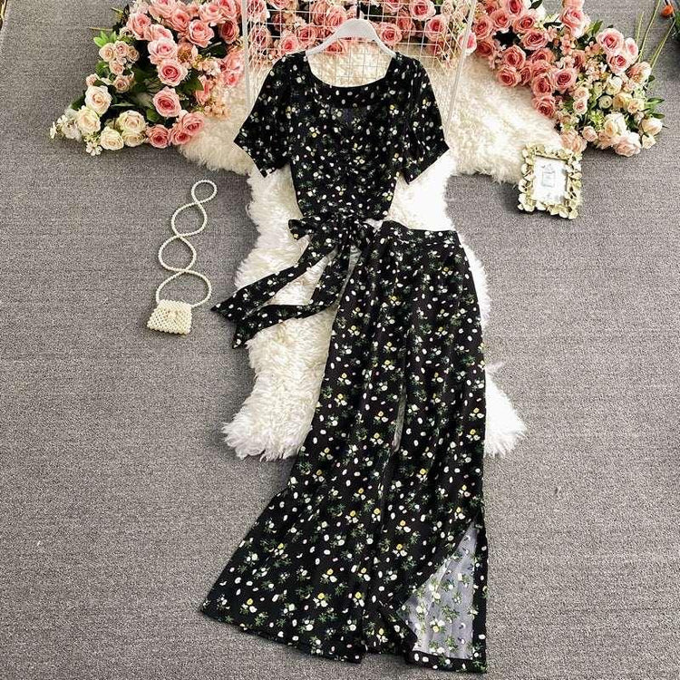 Black floral print short sleeve jumpsuit with wide-leg pants, lightweight fabric, relaxed fit
