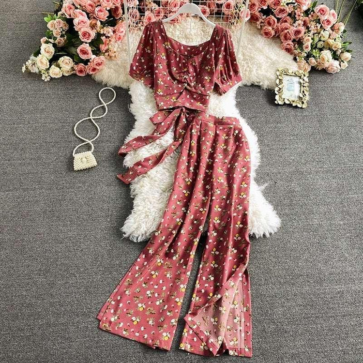 Pink floral two-piece set with short sleeve top and wide-leg pants, lightweight material, relaxed fit