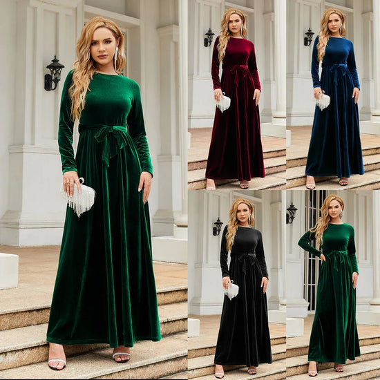 Woman wearing long-sleeve velvet maxi dress with belted waist in green, burgundy, blue, and black, fitted silhouette, elegant evening wear.