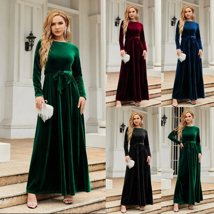 Woman wearing long-sleeve velvet maxi dress with belted waist in green, burgundy, blue, and black, fitted silhouette, elegant evening wear.
