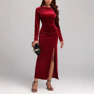 Woman in a fitted velvet burgundy long-sleeve maxi dress with side slit, elegant style