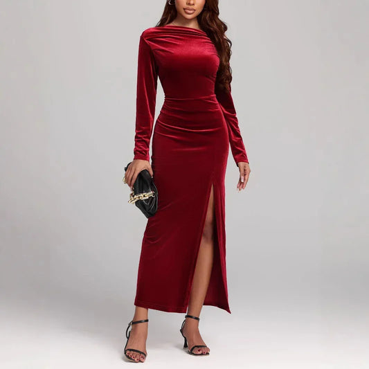 Woman in a fitted velvet burgundy long-sleeve maxi dress with side slit, elegant style