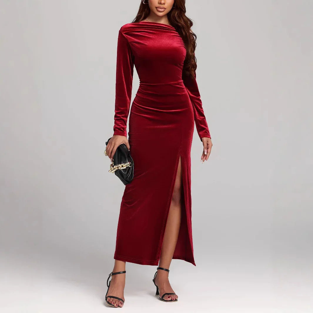 Woman in fitted red velvet long sleeve maxi dress with side slit, elegant evening wear