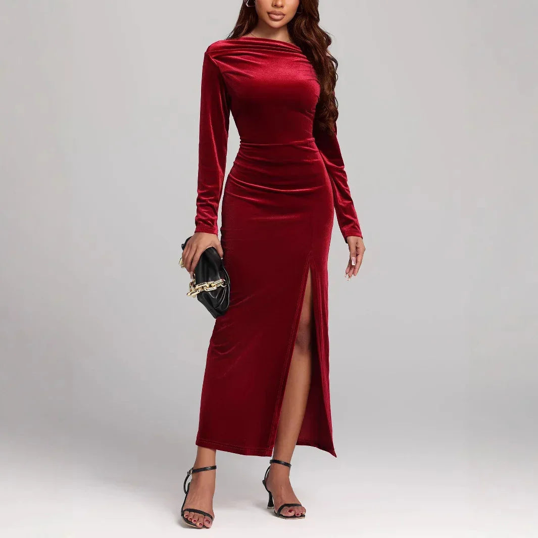 Woman in fitted red velvet long sleeve maxi dress with side slit, elegant evening wear