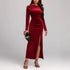 Woman in fitted red velvet long sleeve maxi dress with side slit, elegant evening wear