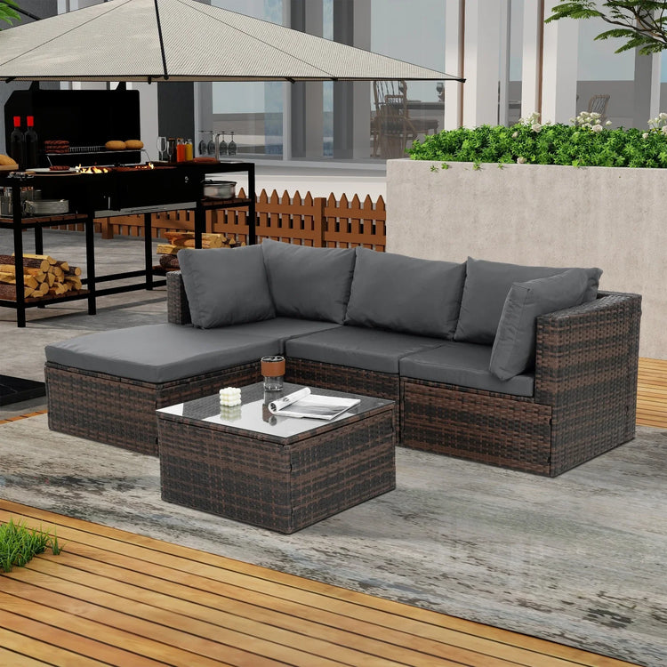 Outdoor patio set with dark rattan sectional sofa and gray cushions, matching coffee table