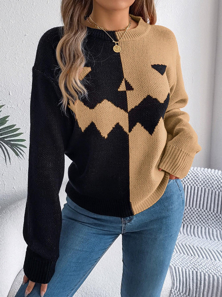 Colorblock black and beige knit sweater with pumpkin face design, relaxed fit, paired with jeans