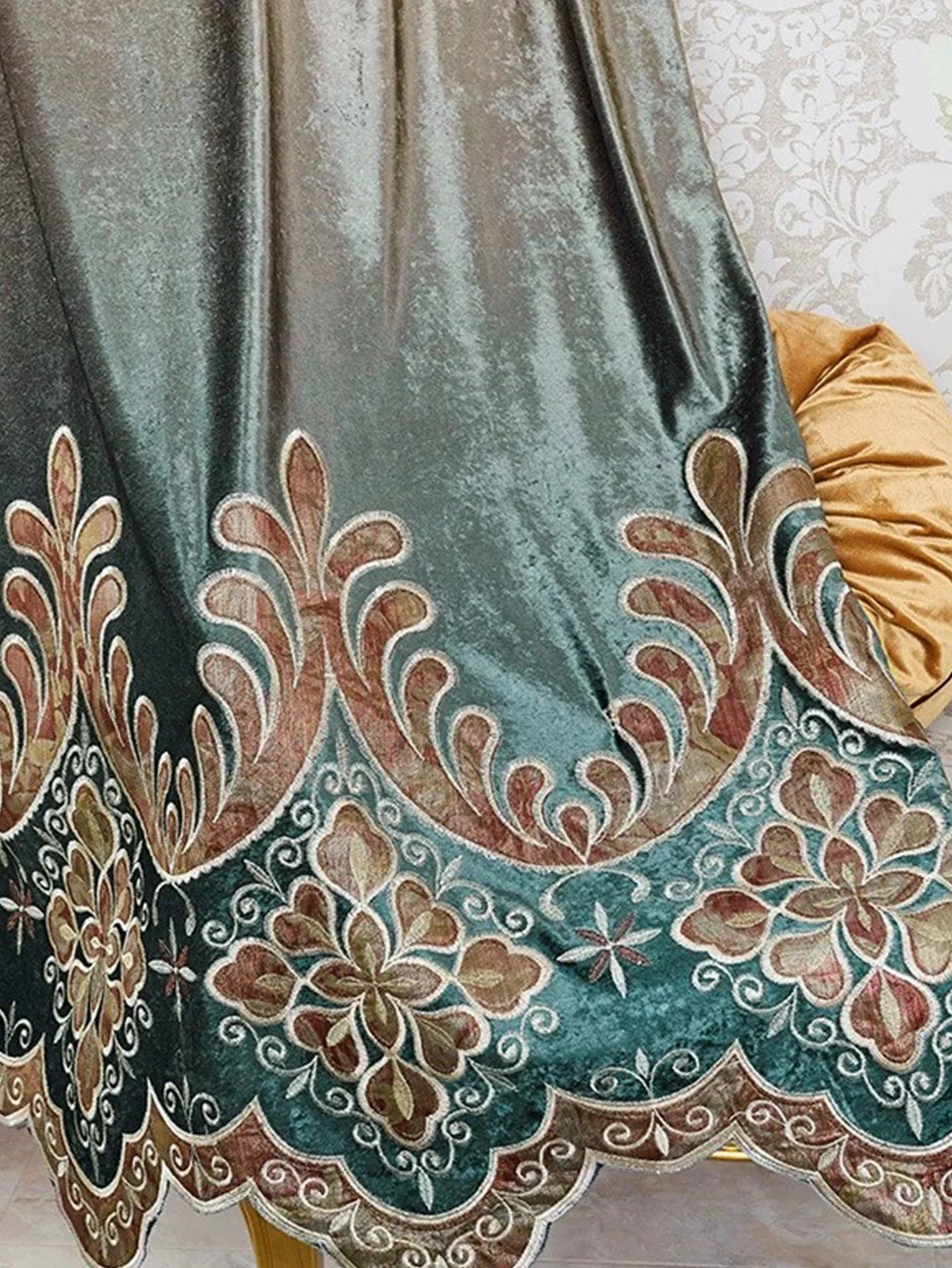 Velvet curtain in teal and gold with ornate embroidered floral patterns and scalloped hem