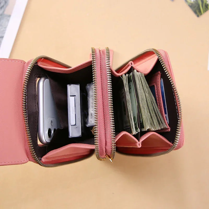 Pink zippered wallet with multiple compartments, holds cash, cards, and smartphone, faux leather