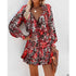 Woman in a red and black animal print long sleeve mini dress with relaxed fit and flowy skirt