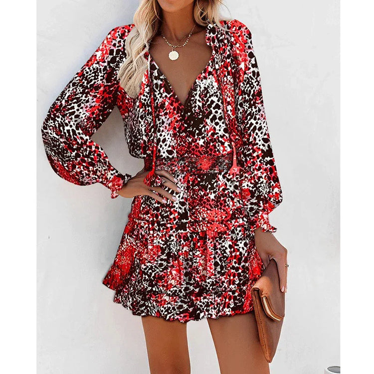 Woman in a red and black animal print long sleeve mini dress with relaxed fit and flowy skirt