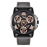 Black and gold skeleton watch with visible gears and gray leather strap, modern design.