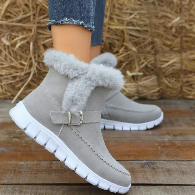 Light grey faux fur ankle boots with suede finish, white rubber sole, and casual fit