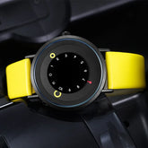 Modern analog watch with unique black dial, yellow markers, and a bright yellow leather strap