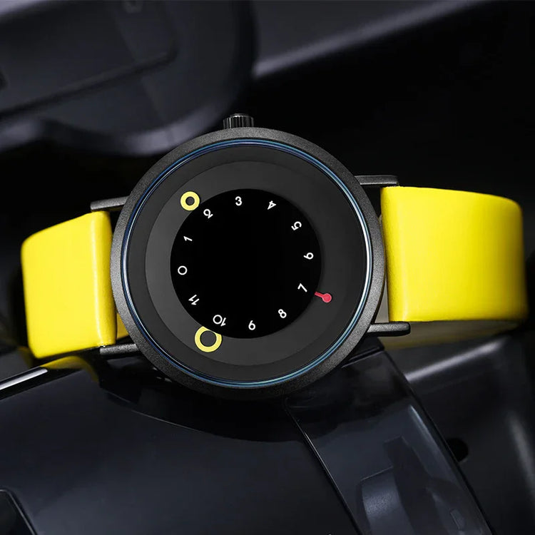 Modern analog watch with unique black dial, yellow markers, and a bright yellow leather strap