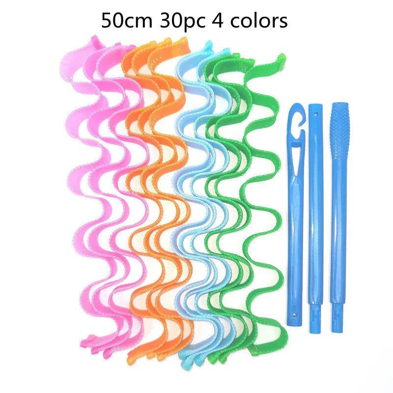 Colorful plastic hair curlers in pink, orange, blue, and green with blue styling tools