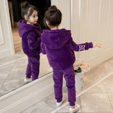 Girl in plush purple hoodie and jogger pants set, relaxed fit, standing by a mirror.