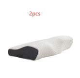 Contoured memory foam pillow with white textured cover and black side panel, ergonomic shape