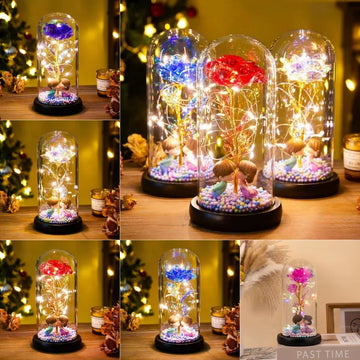 Glass dome LED night lights with colorful artificial roses, fairy lights, and figurines on wooden table, cozy warm lighting.