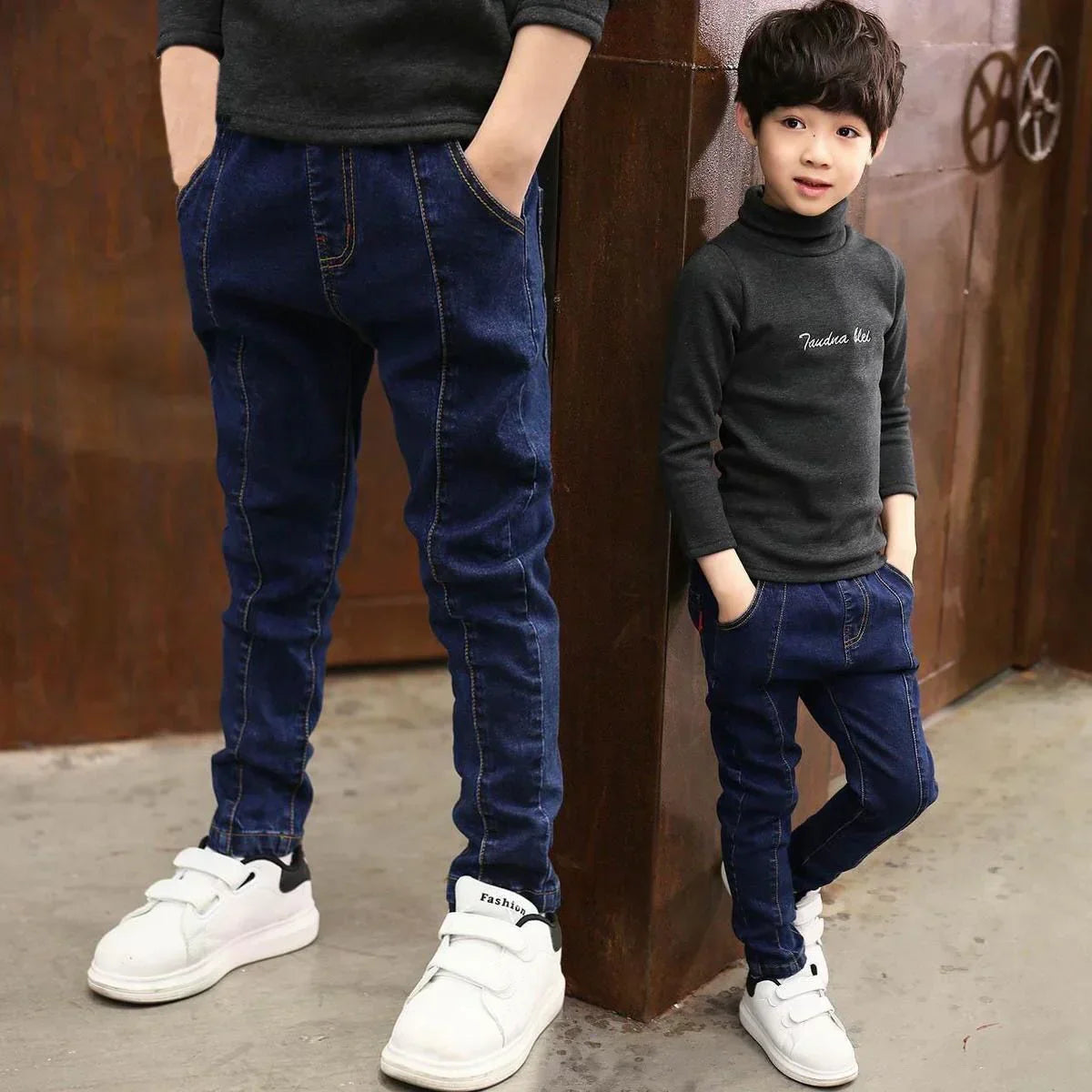 Kids wearing slim fit dark blue denim jeans with dark long sleeve tops and white sneakers