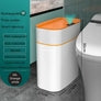 White and orange rectangular smart trash can with automatic sensor, waterproof, in modern bathroom