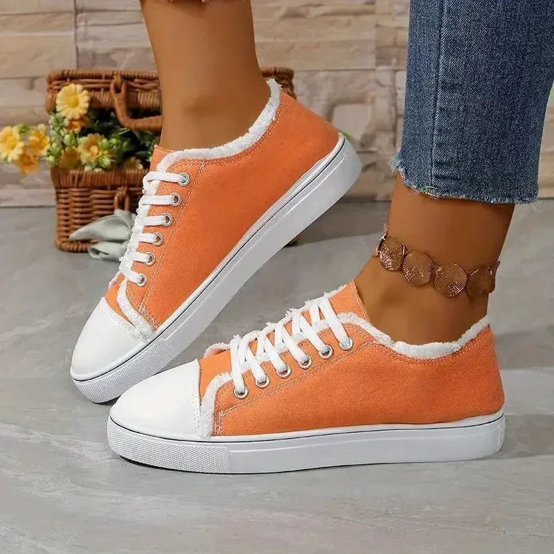 Women's orange canvas sneakers with white laces and soles, low-top fit, casual style